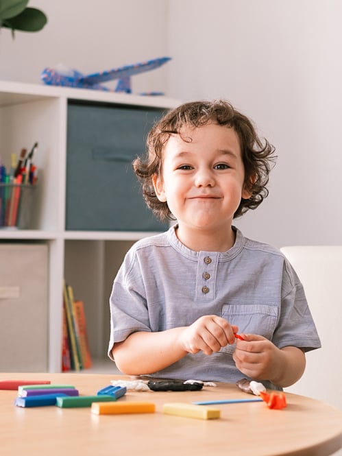 a-little-curly-haired-boy-sculpts-from-plasticine